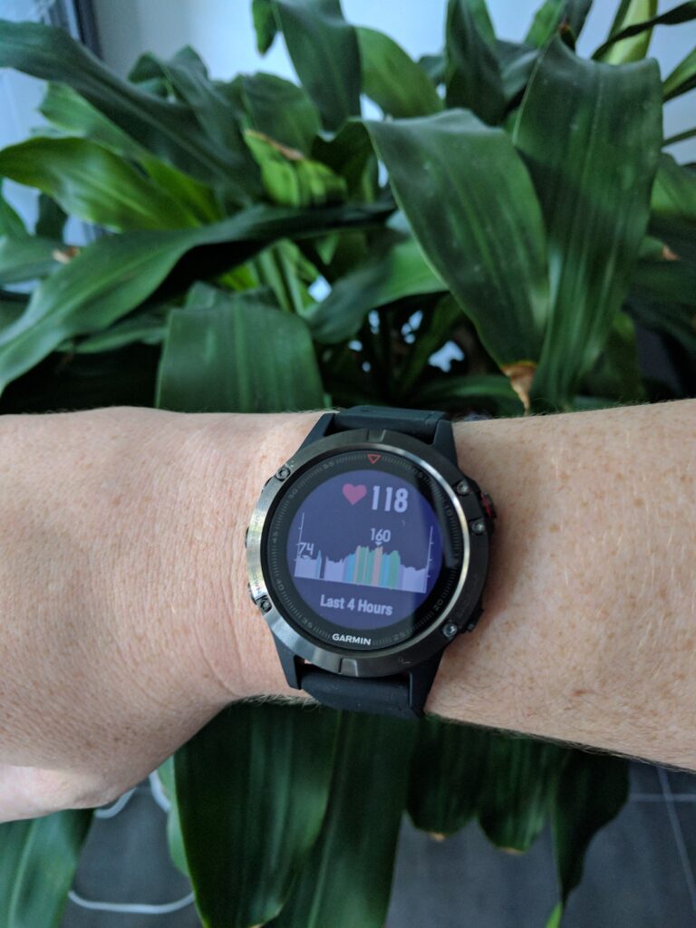 Garmin Fenix 5 with heart rate screen, inside with ambient light, fully readable with no backlight.