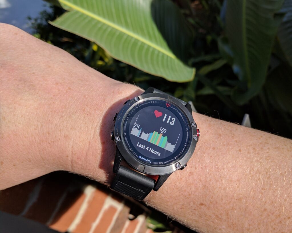 Garmin Fenix 5 in direct sunlight, showing the heart rate sensor (max of 160 and min 74.