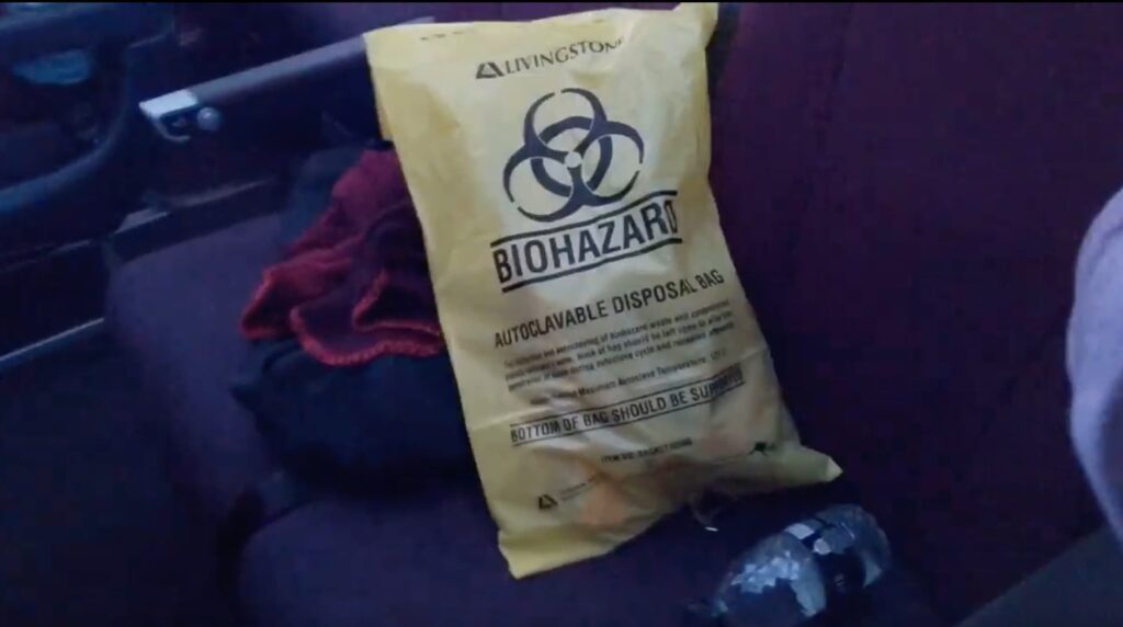 A yellow bag with a biohazard label