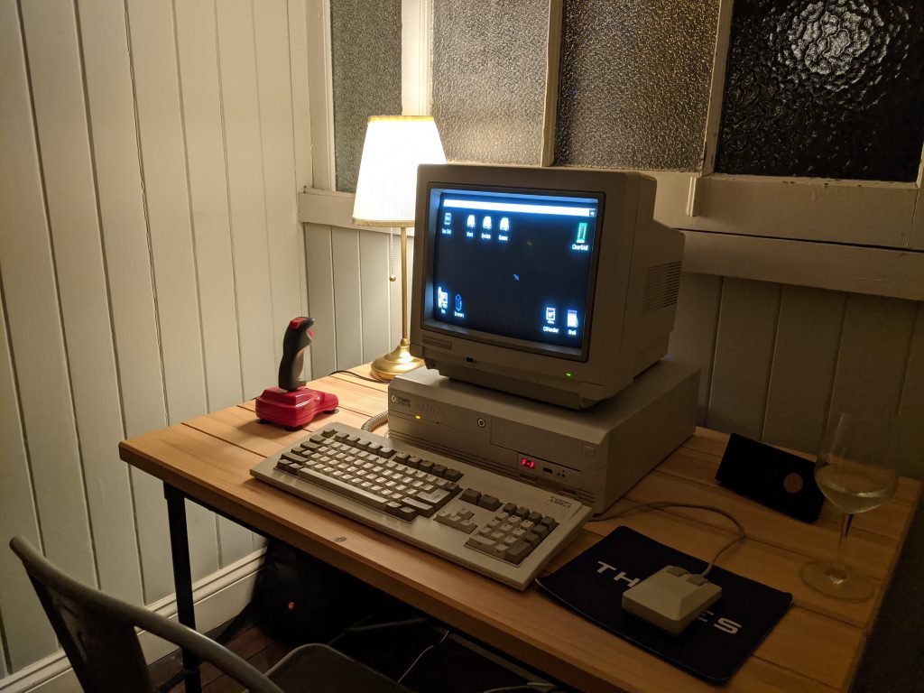 Amiga 4000D on a desk with a glass of wine.