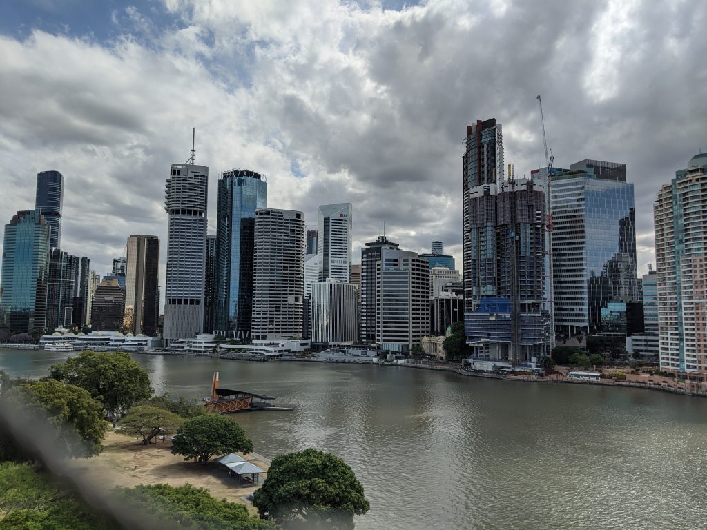 The Brisbane skyline against a backdrop of rolling clouds. It's a bright day, but threatening to rain.