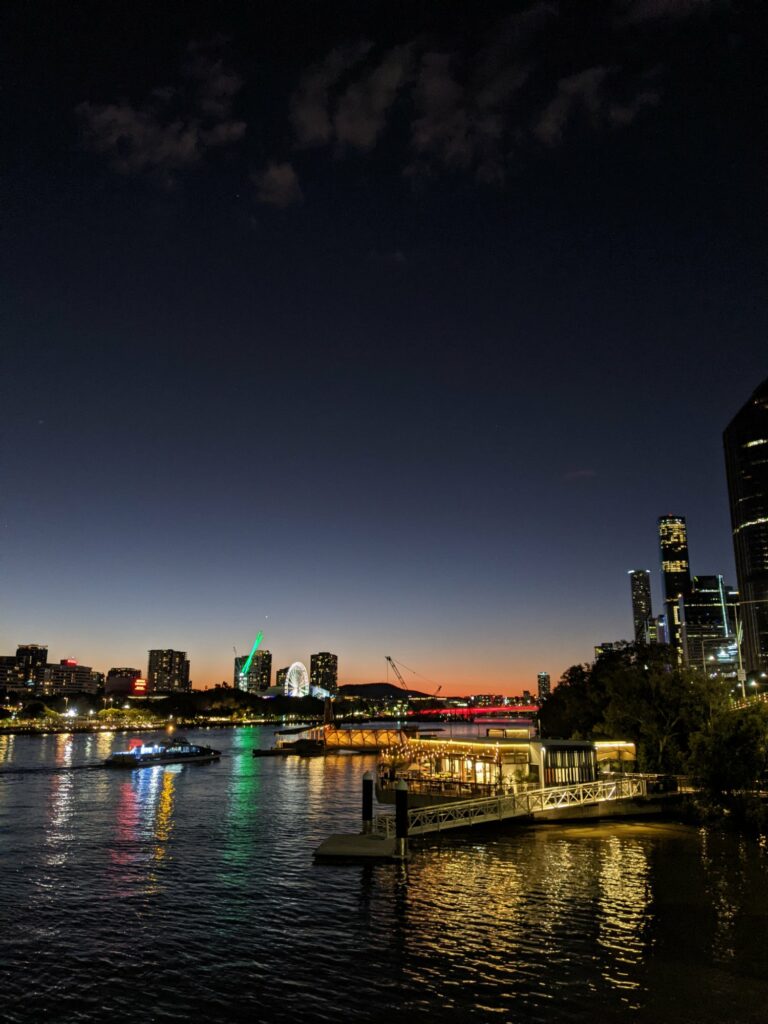 Later in the evening the sun has gone down further leaving a fiery red on the horizon. A CityCat pools into the stop.