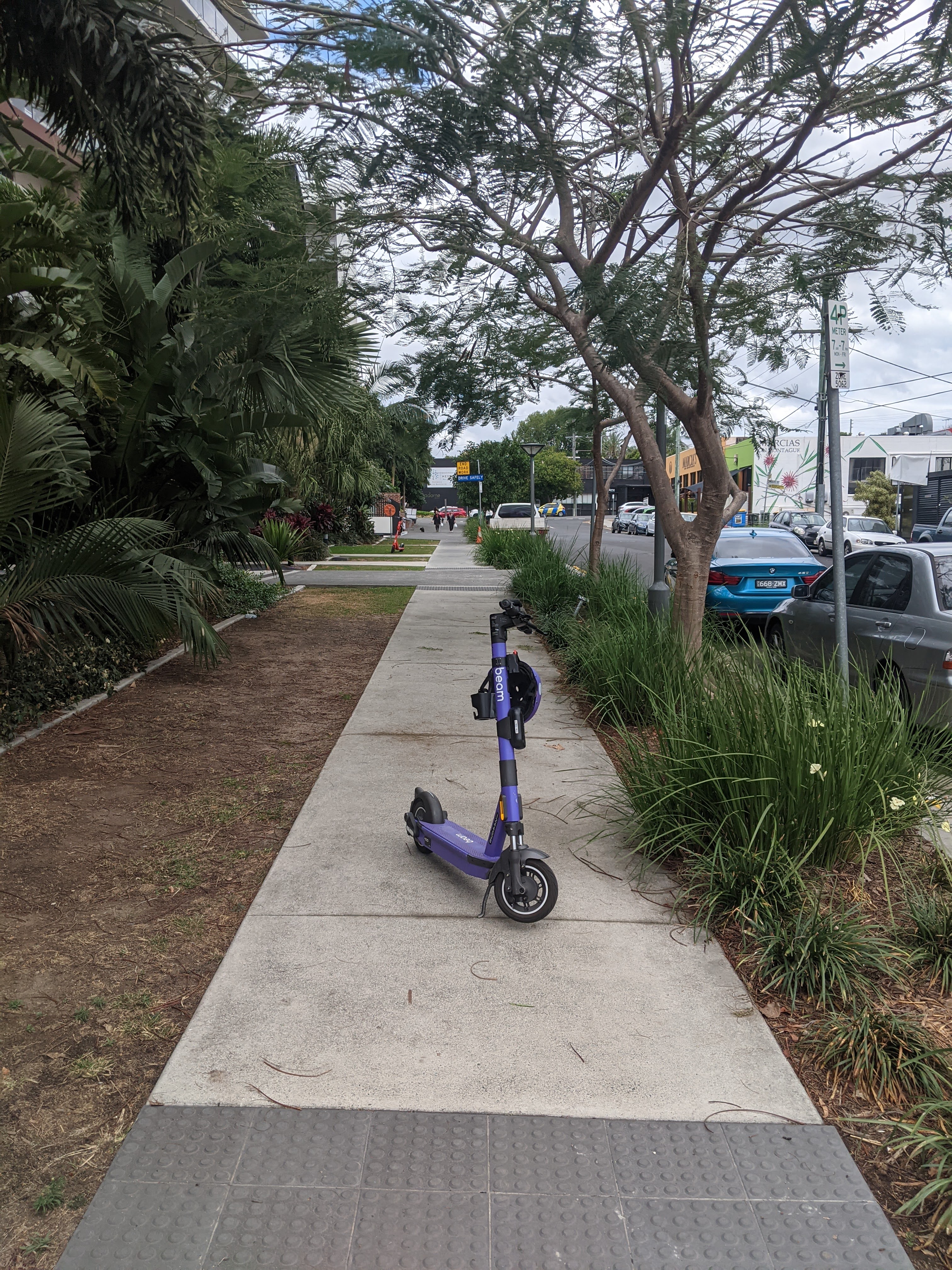 A purple Beam scooter parked smack in the middle of the footpath. Some people are just the worst hey?