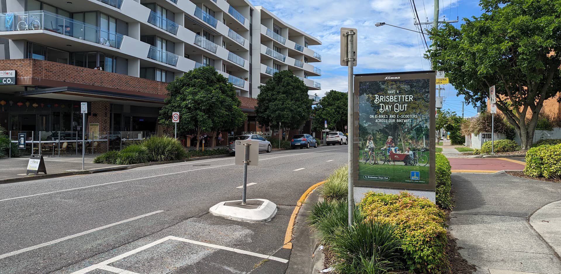 An old Citycycle parking spot turned into motorbike parking. A small billboard says "have a Bris-better day out on e0-bikes and e-scooters across out bikeways"