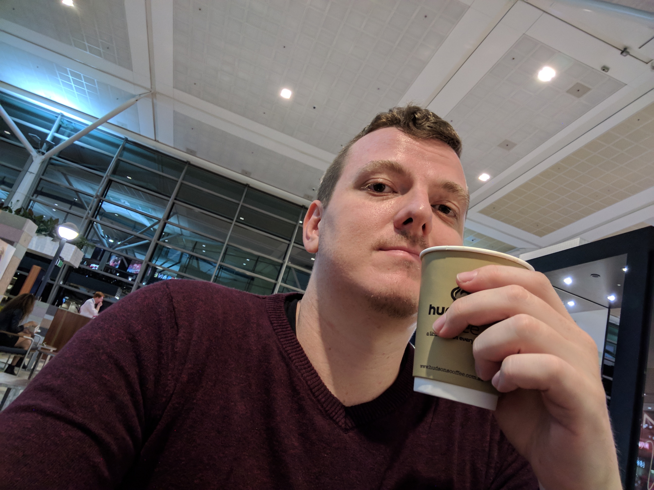 Me drinking a coffee at Brisbane International.
