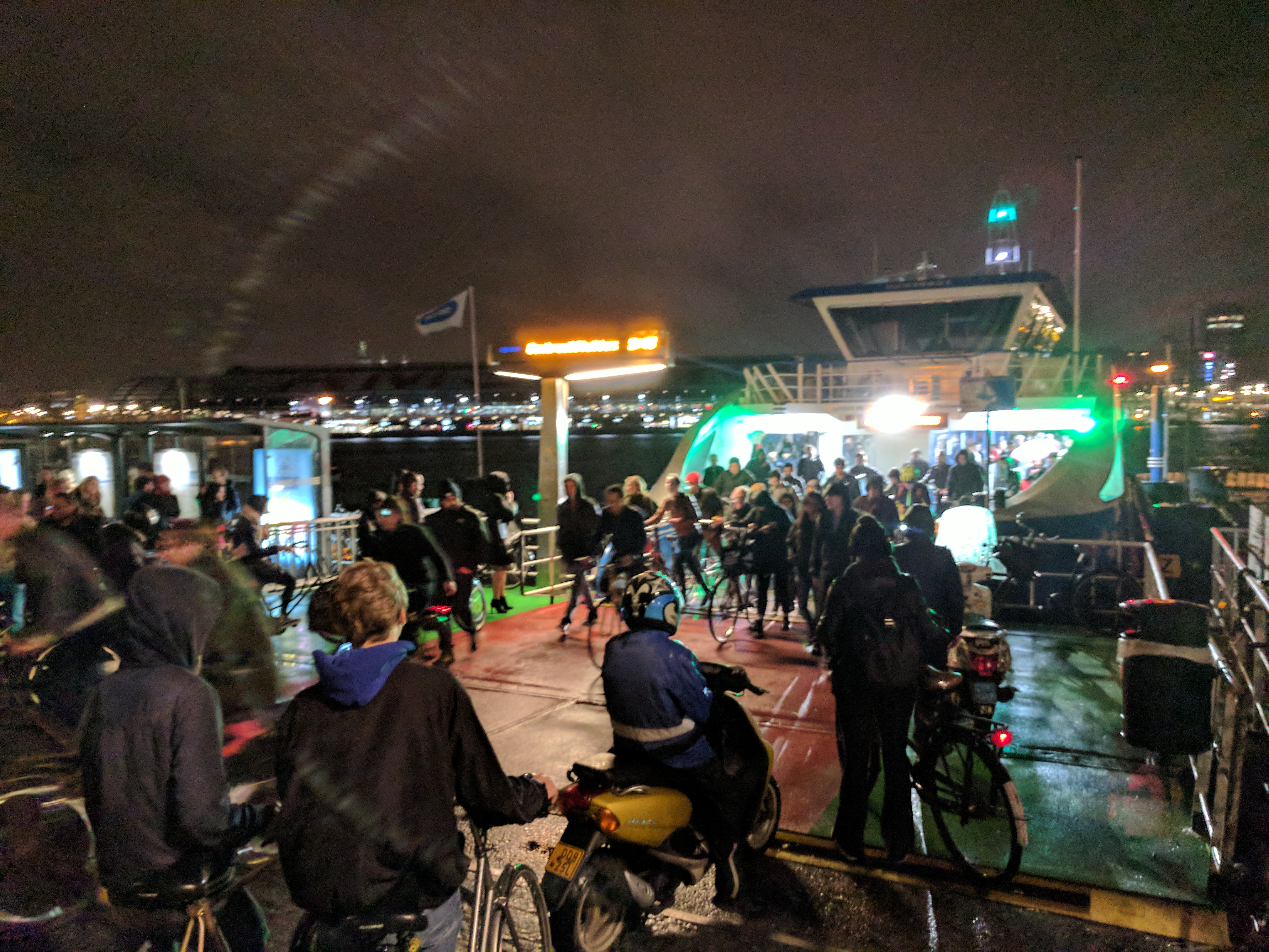 The ferry heading back to Amsterdam. The gates have just opened and a rush of people are getting off. There are approximately six billion people on bikes and scooters waiting to board.