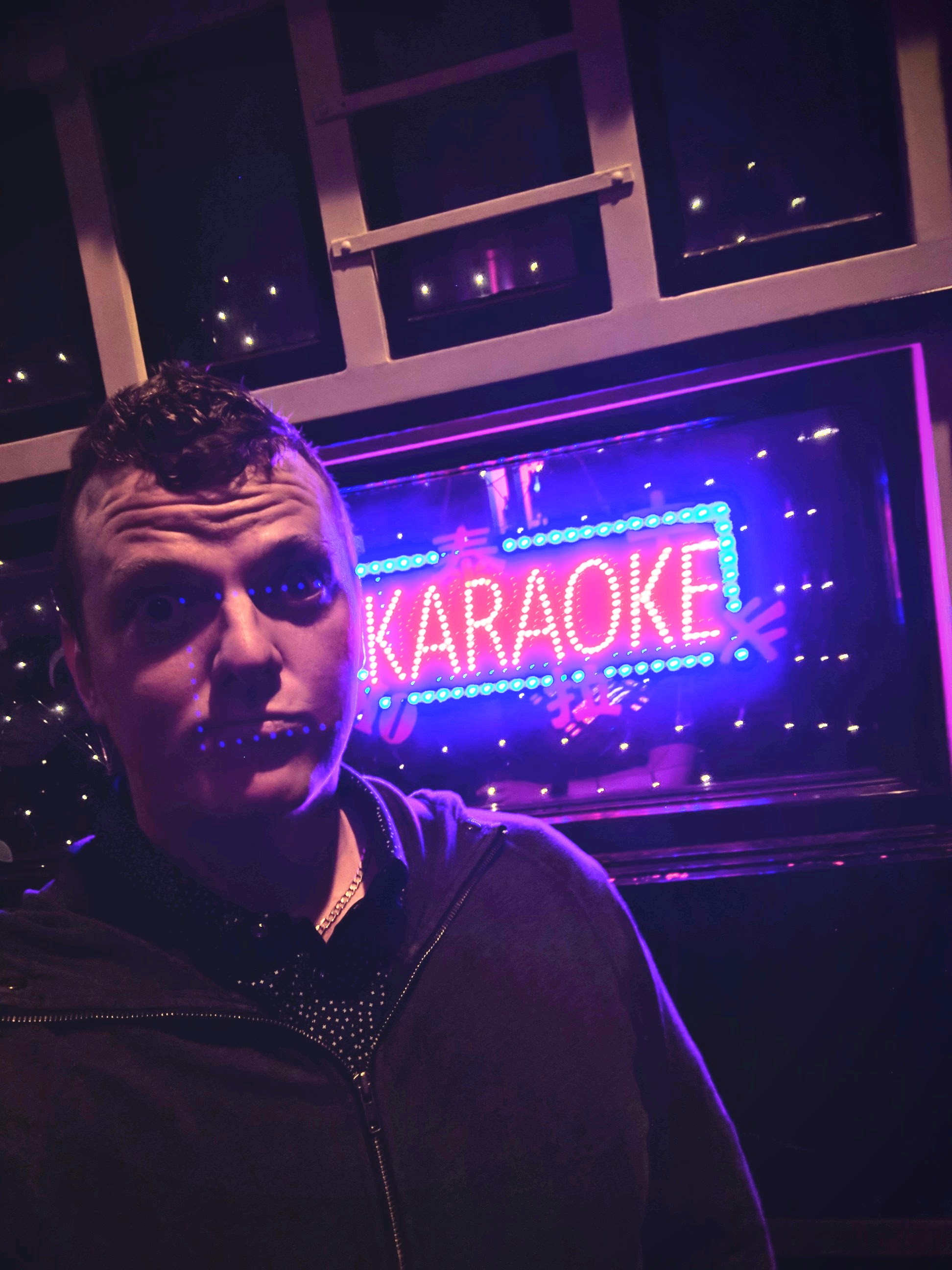 Me in front of the Karaoke sign.