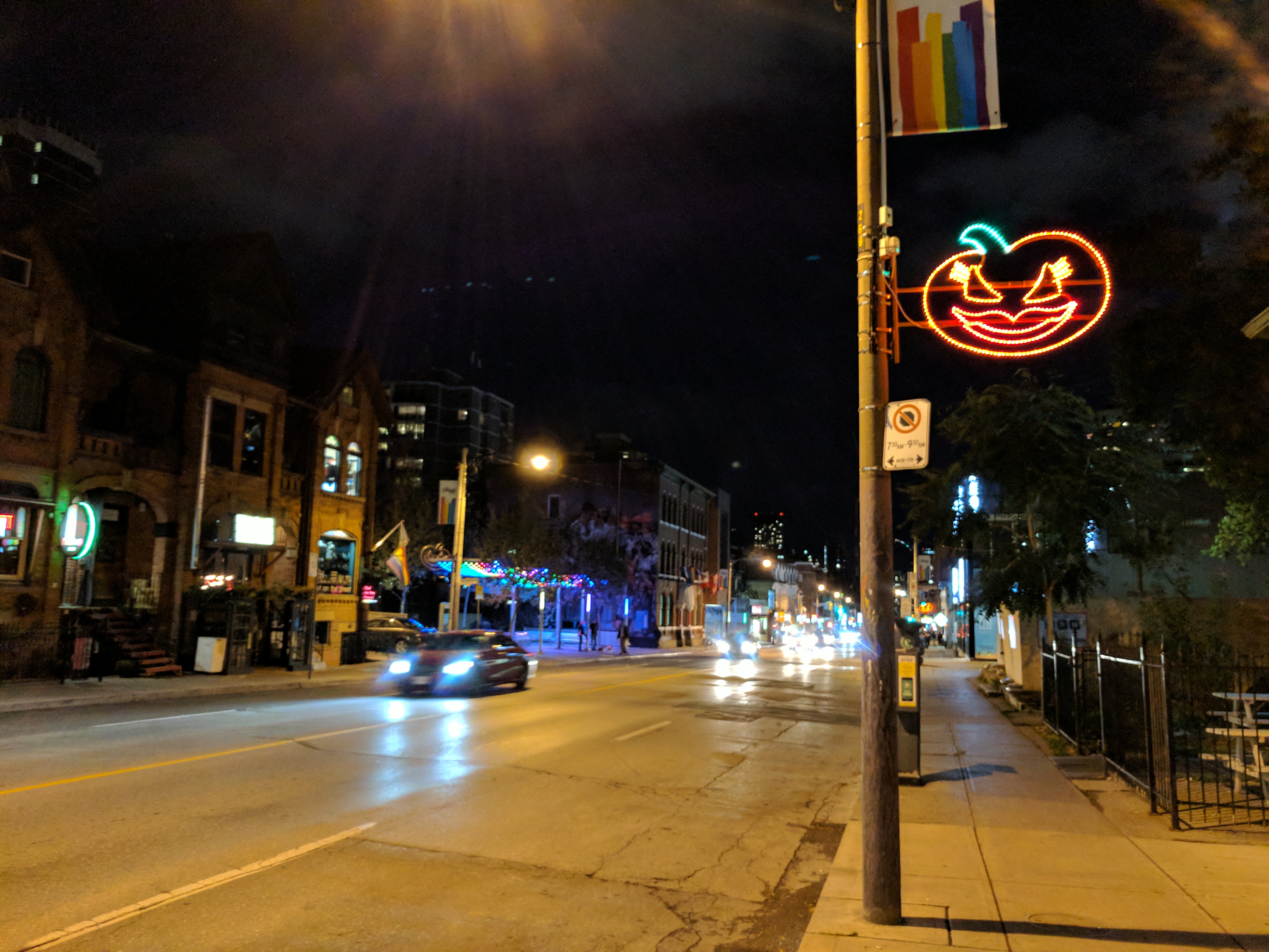 The gay street, there's a rainbow flag and a halloween pumpkin on the lightpost.