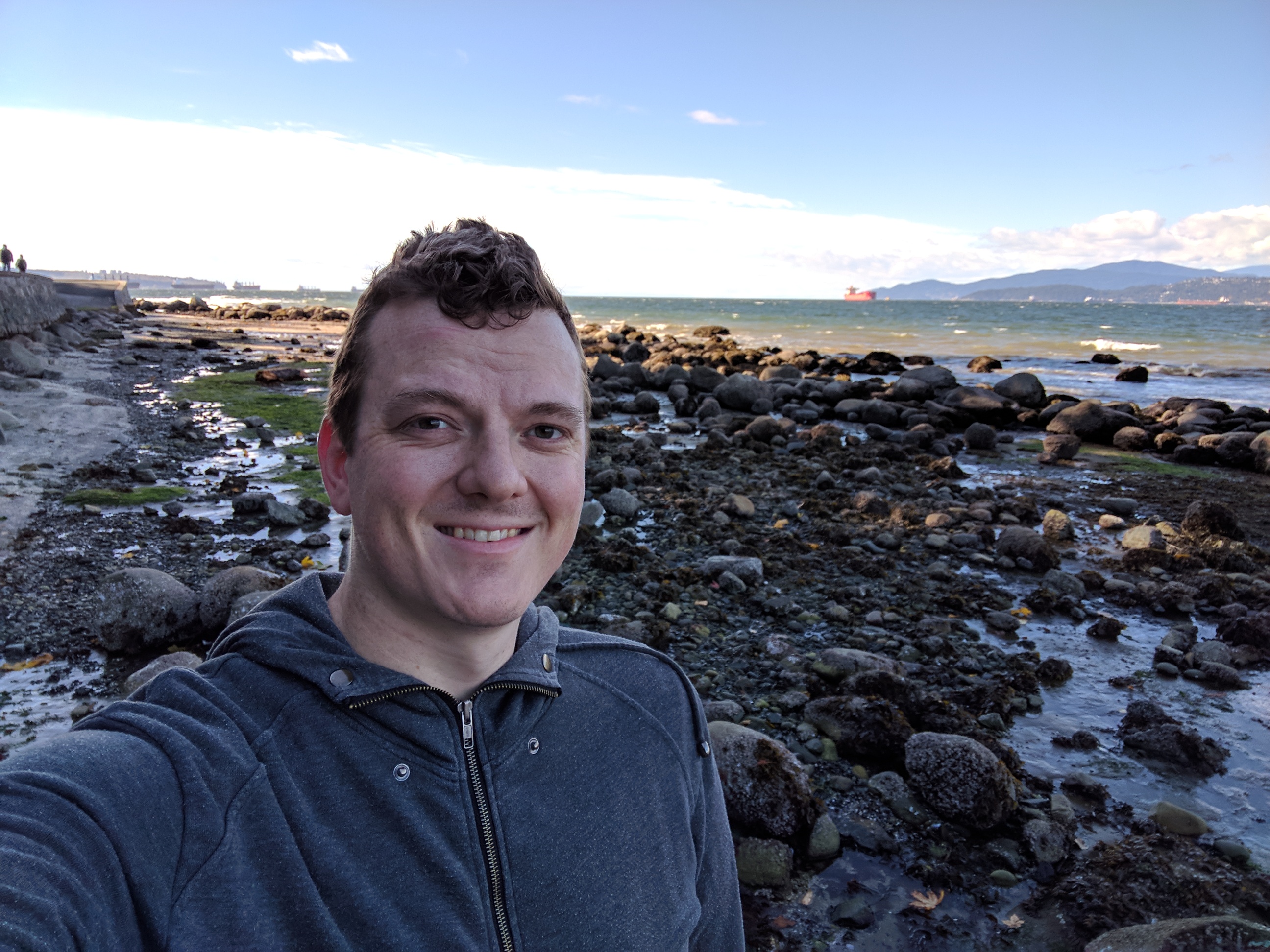 It's me, hanging out at Burrard Inlet at low tide. There's a bunch of massive ships off in the distance.