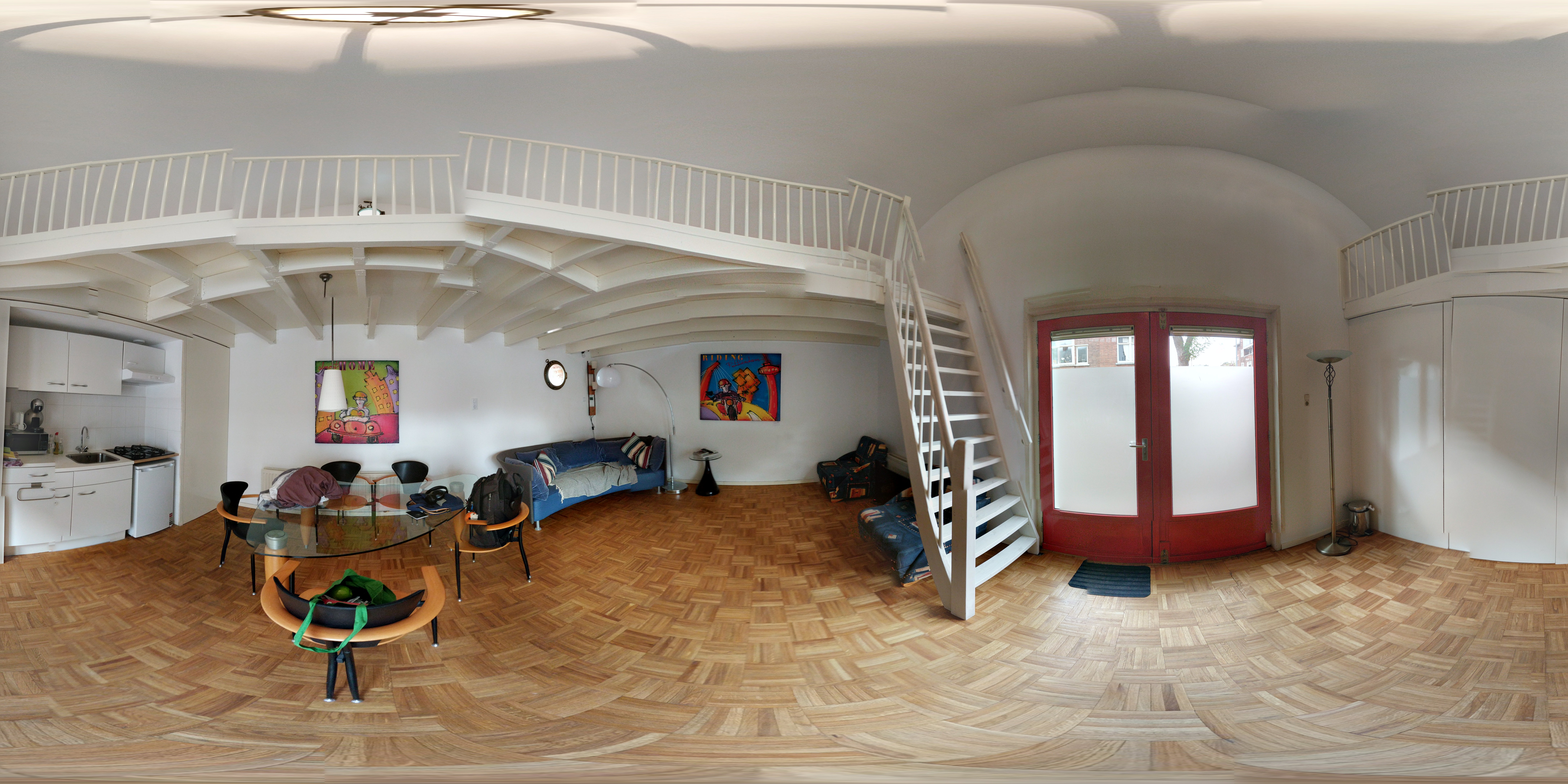 A badly stitched panorama of a cosy under-bridge apartment.