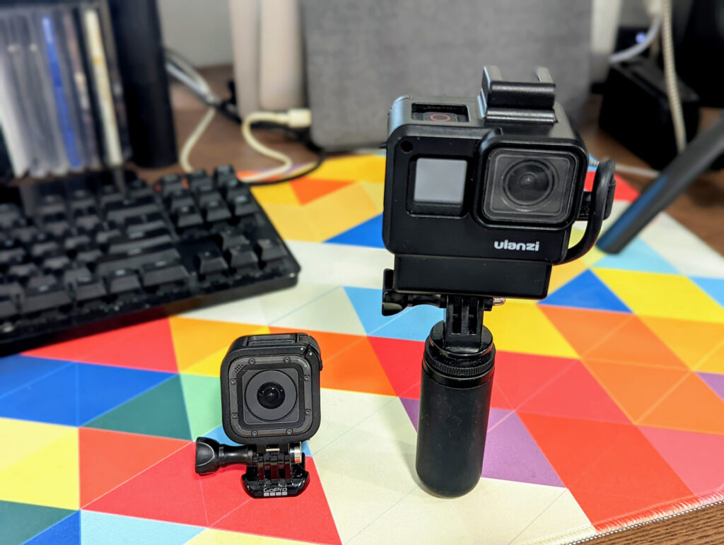 The GoPro Session 5 and Hero 7. The 7 is inside an Ulanzi cage on a small handle.