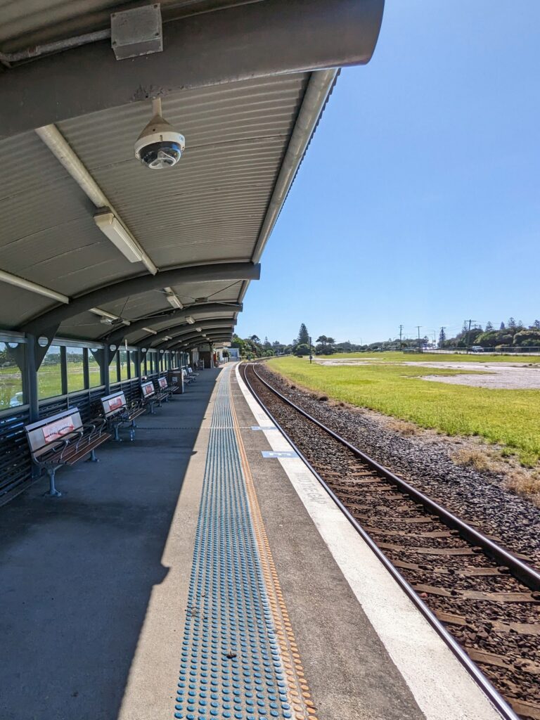 Under the curvy tin roof at Coffs Harbour station, waiting for the train.