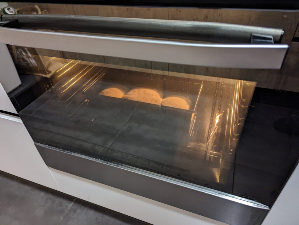 Peering into the oven, we can see the bread rising and forming a crust.