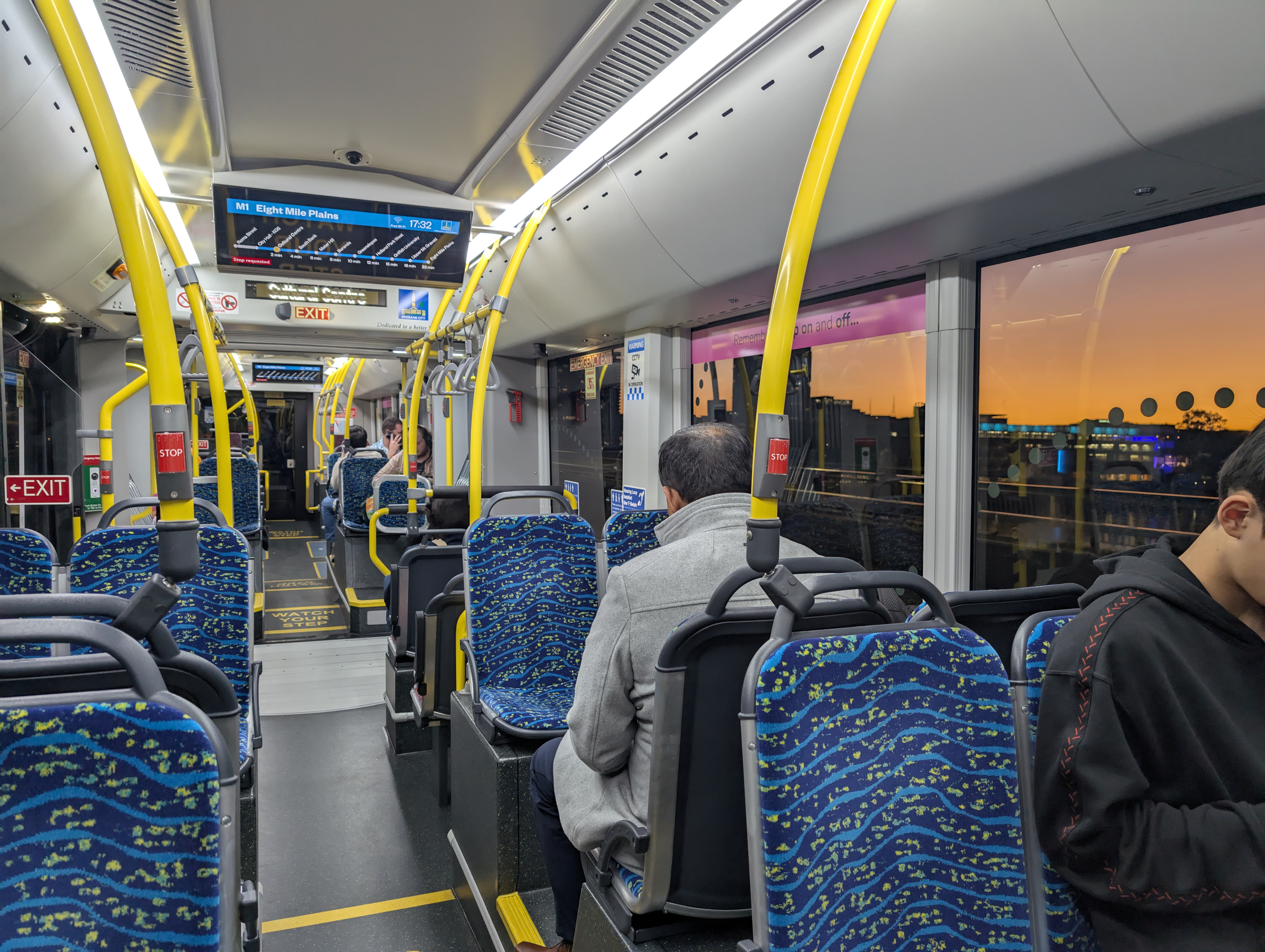 The inside of the metro at sunset. It's blue fabric seats, it's just a modern bus.