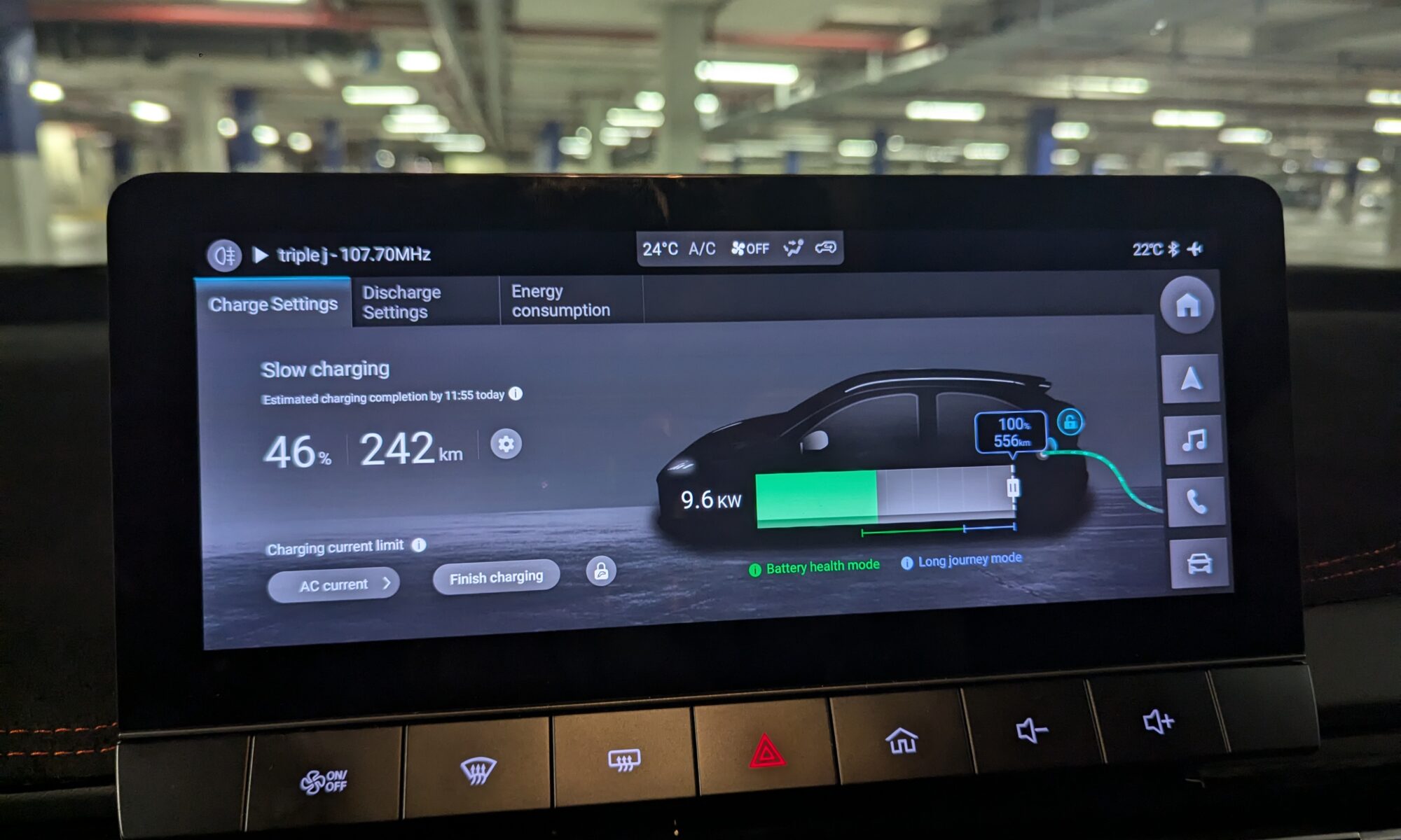 A car dashboard shows a car charger slow-charging at 46%