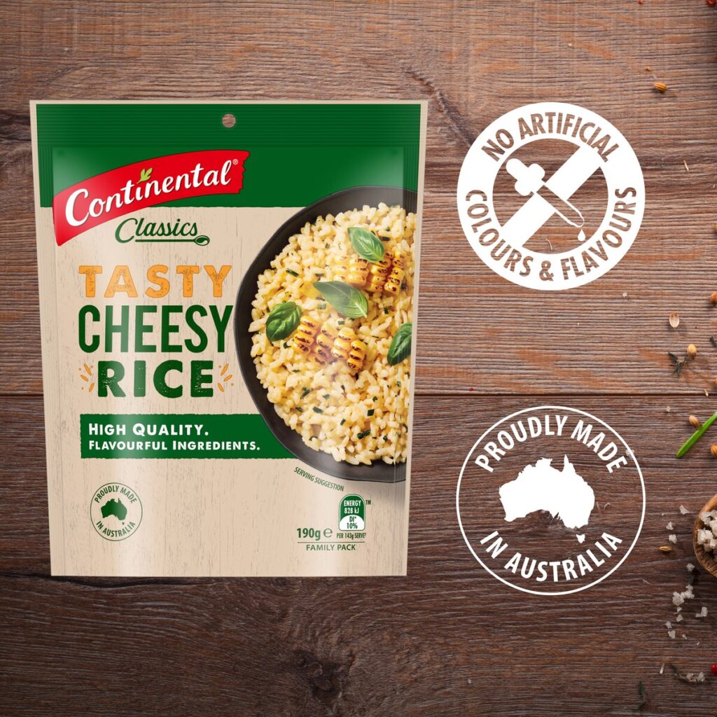 The old cheesy rice packaging was sort of tan, green and red. The packaging is composited against a wooden benchtop with badges proclaiming: "no artificial colours & flavours" and "proudly made in Australia"